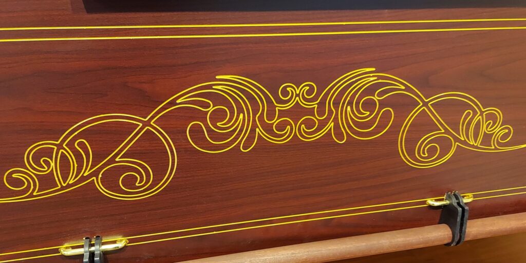 Custom golden engraving detail on casket. 